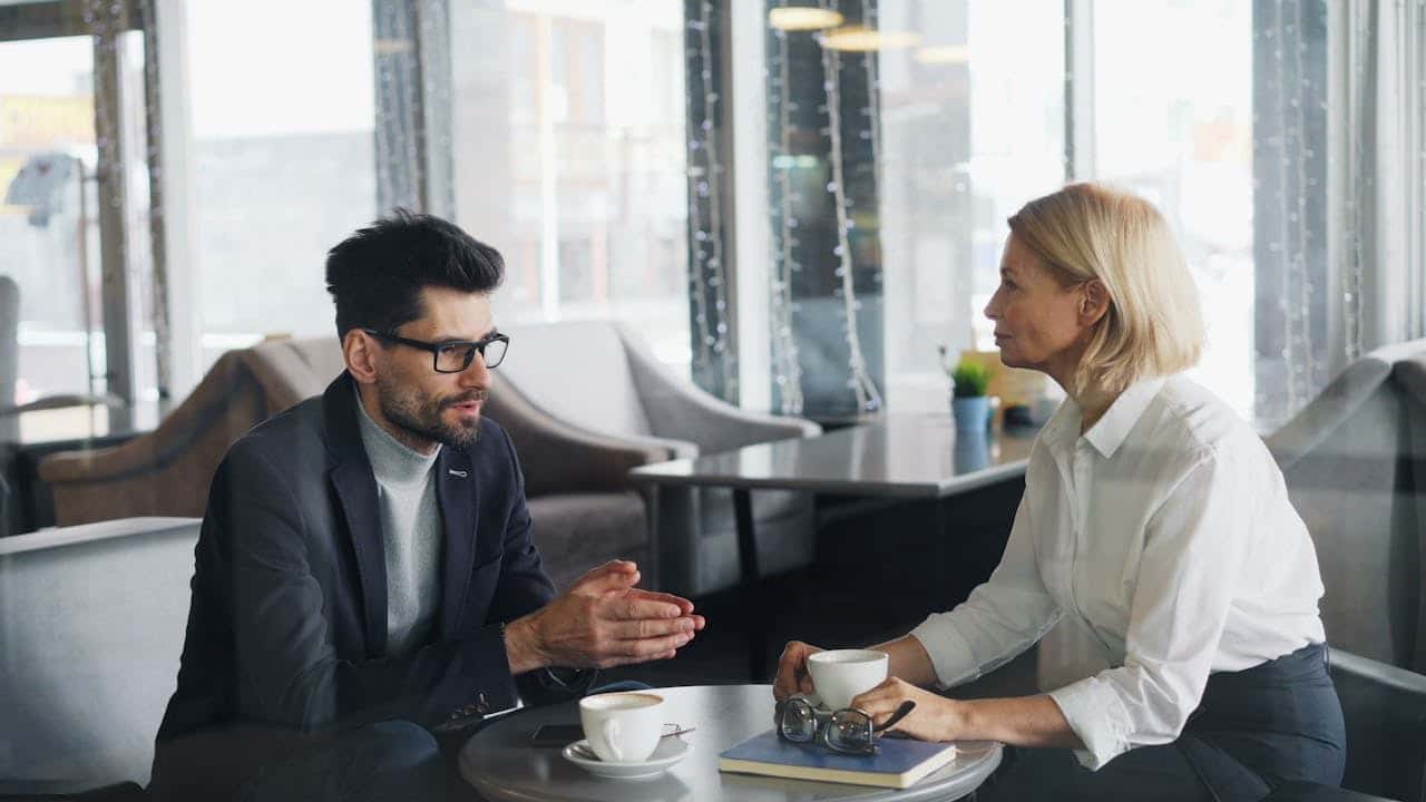 A client and consultant in discussion at a coffee meeting